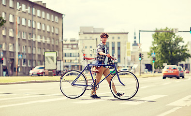 Image showing young man with fixed gear bicycle on crosswalk