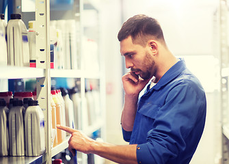 Image showing auto mechanic with clipboard at car workshop