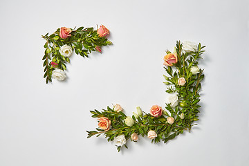 Image showing Horizontal corner frame from evergreen twigs and flowers.