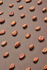 Image showing Organic cocoa beans pattern on a brown background.