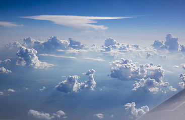 Image showing Part of plane wing on a background of blue cloudy sky.