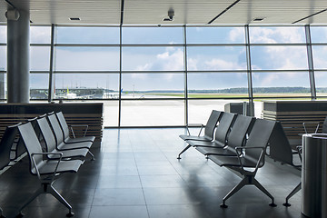 Image showing Empty chairs at waiting area in the airport terminal.