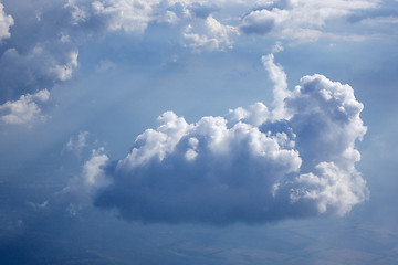 Image showing Sun beams is lighting through the big white clouds.