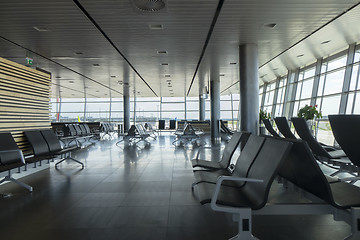 Image showing Airport terminal with empty chairs for waiting departure.