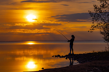 Image showing Woman fishing on Fishing rod spinning in Norway.