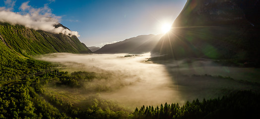 Image showing Morning mist over the valley among the mountains in the sunlight