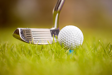 Image showing Golf ball on tee in front of driver