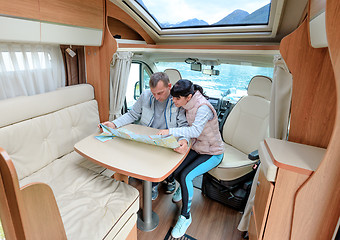 Image showing Couples in RV Camper looking at the local map for the trip.