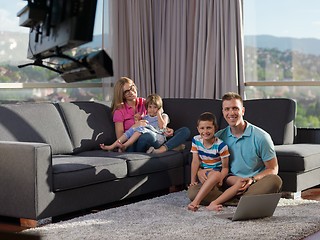 Image showing young happy family relaxing at home