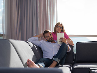 Image showing couple relaxing at  home with tablet computers