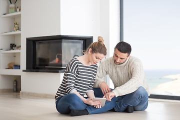 Image showing Young Couple using digital tablet on cold winter day