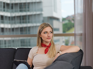 Image showing young woman on sofa at home surfing web