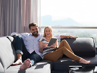 Image showing couple relaxing at  home with tablet computers