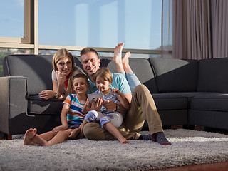 Image showing happy young couple spending time with kids