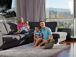 Image showing young happy family relaxing at home