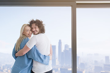 Image showing young couple enjoying morning coffee by the window