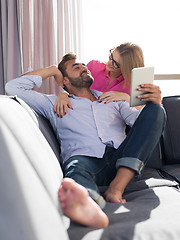 Image showing couple relaxing at  home with tablet computers