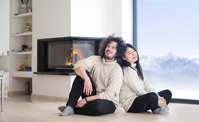 Image showing happy multiethnic couple  in front of fireplace