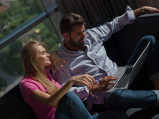 Image showing couple relaxing at  home using laptop computer