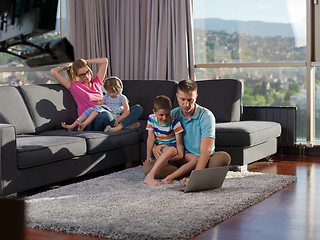 Image showing young happy family relaxing at home