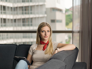 Image showing young woman on sofa at home surfing web