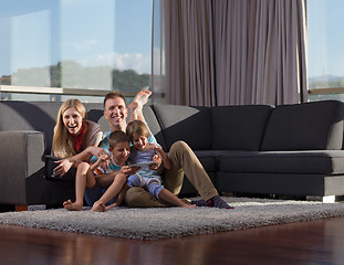 Image showing happy young couple spending time with kids