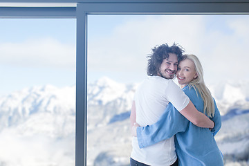 Image showing young couple enjoying morning coffee by the window