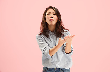 Image showing Beautiful female half-length portrait isolated on pink studio backgroud. The young emotional surprised woman