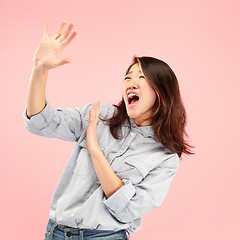 Image showing Portrait of the scared woman on pink