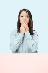 Image showing Young woman covering her mouth