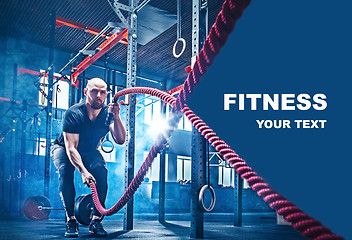 Image showing Men with battle rope battle ropes exercise in the fitness gym.