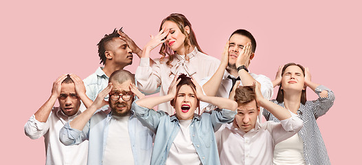 Image showing People having headache. Isolated over pink background.
