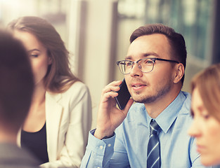 Image showing businessman calling on smartphone at office