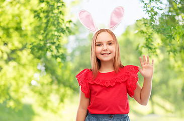 Image showing happy girl wearing easter bunny ears waving hand