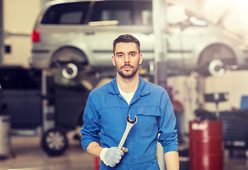 Image showing auto mechanic or smith with wrench at car workshop