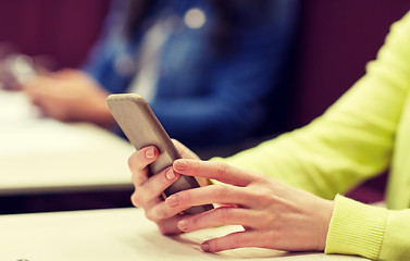 Image showing close up of student with smartphones on lecture