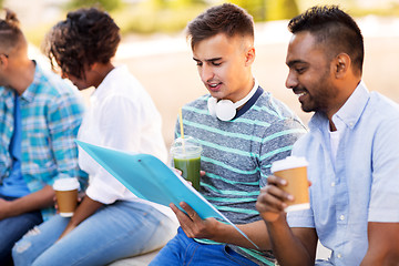 Image showing students with notebook and takeaway drinks