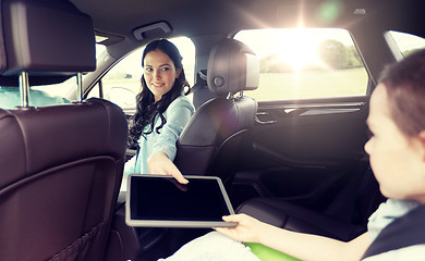 Image showing happy family with tablet pc driving in car