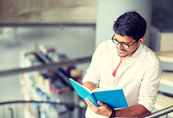 Image showing hindu student boy or man reading book at library