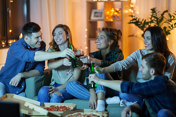 Image showing friends with drinks and pizza watching tv at home