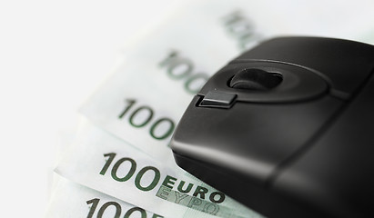 Image showing close up of computer mouse on euro money