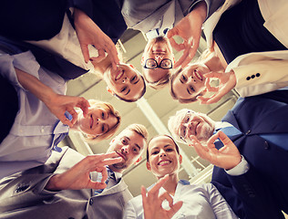 Image showing business people showing ok hand sign at office