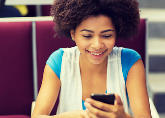 Image showing african student girl with smartphone on lecture