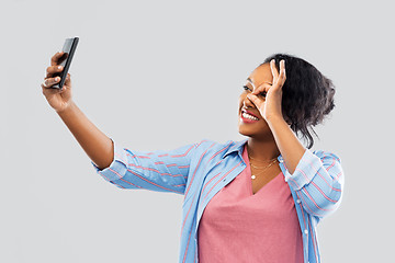 Image showing african american woman taking selfie by smartphone