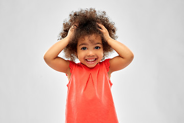 Image showing overwhelmed african american girl holding to head