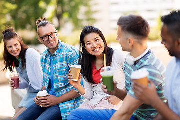 Image showing friends drinking coffee and juice talking in city