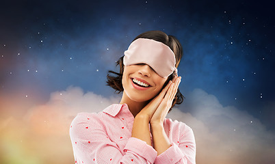 Image showing happy young woman in pajama and eye sleeping mask