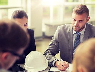 Image showing architects with helmet and clipboard at office