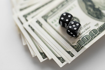 Image showing close up of black dice on dollar money