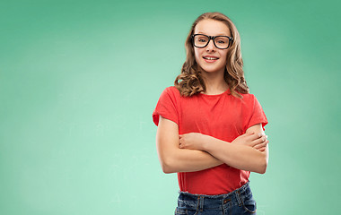 Image showing smiling student girl in glasses over green board